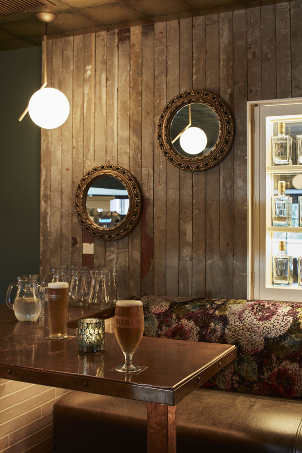 Bar counter, drinks, beautiful floral comfortable seating timber panels copper counter top, decorative wall mirrors