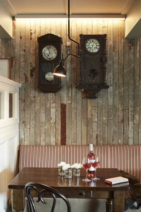Bar, comfortable seating tables timber panels pendant lighting, wall clocks