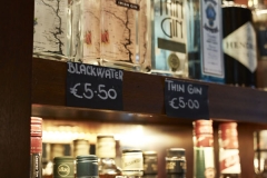 Bar shelving with alcohol bottles signage prices