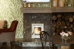 Bar area, comfortable seating, flat screen tv, log fire, cozy area, green foliage wallpaper, beautiful ambience