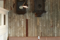Bar, comfortable seating tables timber panels pendant lighting, wall clocks