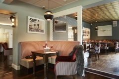 Bar/restaurant seating tables timber panels, flooring, pendant lighting, waitress, ambience